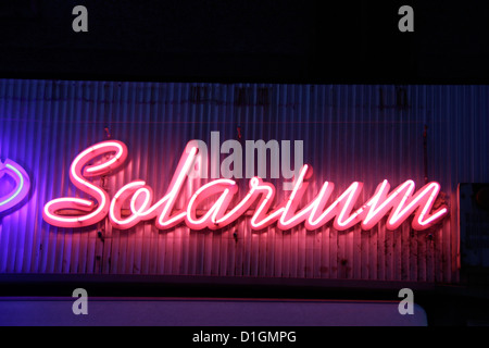 red pink neon solarium shop sign notice Stock Photo