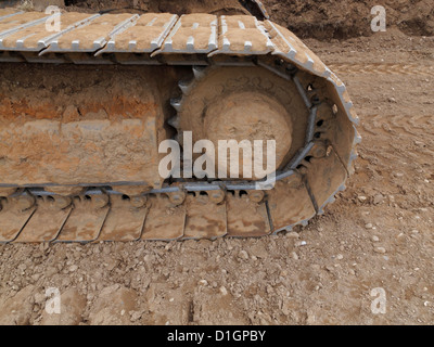 Closeup detail of the caterpillar track of a large tracked excavator on a highway construction site UK