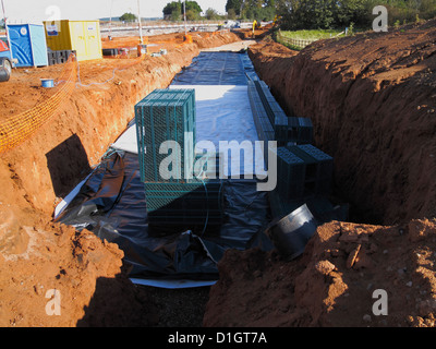 Buried Attenuation chamber using Stormbloc plastic crates Sustainable surface water drainage system SUDS road building UK Stock Photo