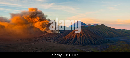 Mount Bromo (Gunung Bromo), an active volcano, erupting at sunrise throwing up ash clouds, East Java, Indonesia, Southeast Asia Stock Photo