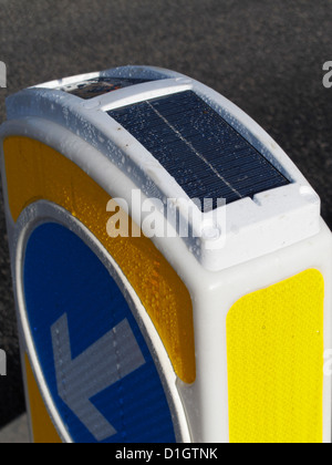 photoelectric photovoltaic cell on top of a solar powered keep left bollard UK Stock Photo