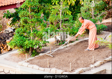 Buddhist monk gardening at a temple on top of Sam Mountain, Mekong Delta, Vietnam, Indochina, Southeast Asia, Asia Stock Photo