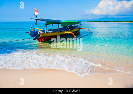 Traditional Indonesian outrigger fishing boat on the island of Gili Meno in the Gili Isles, Indonesia, Southeast Asia, Asia Stock Photo