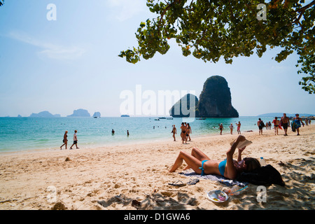 Tourist sunbathing and reading on Ao Phra Nang Beach, Railay (Rai Leh), South Thailand, Southeast Asia, Asia Stock Photo
