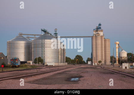 Rail tracks, grain silos and elevator at Redfield, South Dakota, at dusk. Stock Photo