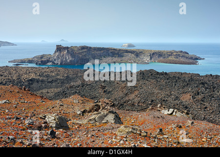 Lava and volcanic rocks with Palea Kameni and Aspronisi islands in the background from Nea Kameni Island, Nea Kameni, Santorini, Greece Stock Photo