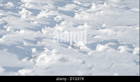 Texture of sharp hilly snowdrift with nice shadows Stock Photo
