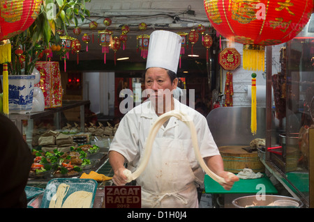 Washington, DC - A worker makes noodles in a Chinese restaurant in Washington's Chinatown neighborhood. Stock Photo