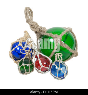 A set of different nautical glass floats tied with rough rope - path included Stock Photo