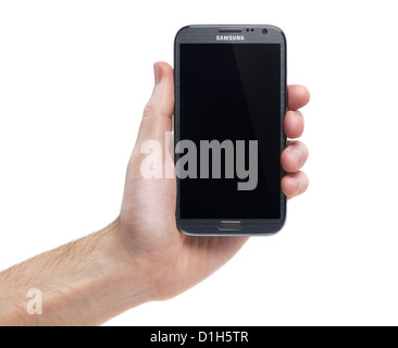 Hand holding Samsung Galaxy Note II smartphone Android phone isolated on white background Stock Photo