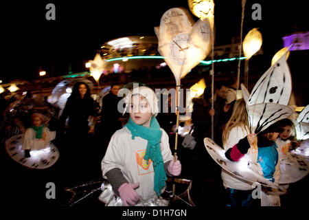 Brighton, UK. Friday 21st December 2012. Burning the Clocks has been a Brighton tradition for almost two decades. This event takes place on the winter solstice, the shortest day of the year. A 2,000-strong parade winds its way through the streets and people pass their handmade paper and willow lanterns – filled symbolically with their hopes and dreams – into a blazing bonfire to “burn the clocks” and welcome in the new longer day. Stock Photo