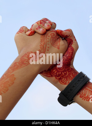 Arm wrestling with henna tinted hand Stock Photo