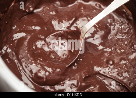 Hot melted chocolate in pan with spoon Stock Photo