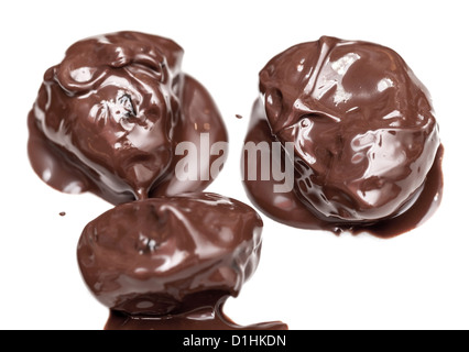 Homemade prunes in chocolate candies isolated on white table background Stock Photo