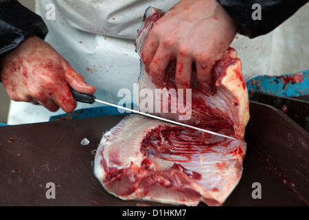 Cutting Czech Christmas carp for customers. Prague, Czech Republic Stock Photo