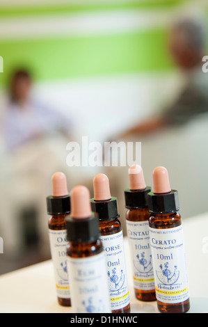 Bach Flowers Extracts with healer and patient in the background Stock Photo