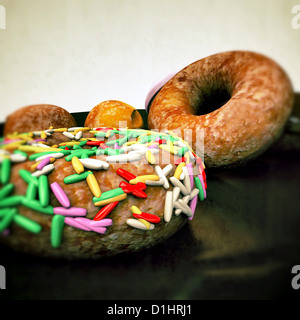 donuts on black reflective plate Stock Photo