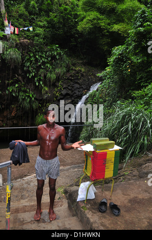 Wet youth, arms outstretched, posing viewing platform, after jumping into plunge pool, Annandale Waterfall, Grenada, West Indies Stock Photo