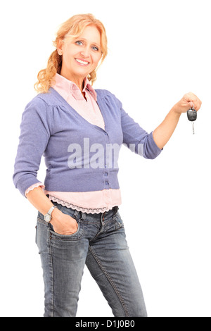 A smiling mature female holding a car key isolated on white background Stock Photo