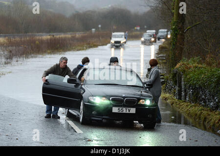 Derwenlas, Ceredigion Wales UK. Monday 24 December 2012. Cars driving through floodwaters on the A487 trunk road at Derwenlas, Ceredigion, near Machynlleth. Despite the road being officially closed traffic still attempted to negotiate the road, with some becoming stuck in the water.  Photo: Keith Morris/Alamy Live News Stock Photo