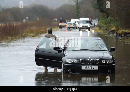 Derwenlas, Ceredigion Wales UK. Monday 24 December 2012. Cars driving through floodwaters on the A487 trunk road at Derwenlas, Ceredigion, near Machynlleth. Despite the road being officially closed traffic still attempted to negotiate the road, with some ,  like this BMW car,  becoming stuck in the water.  Photo: Keith Morris/Alamy Live News Stock Photo