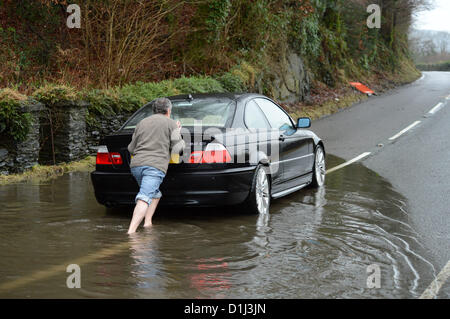 Derwenlas, Ceredigion Wales UK. Monday 24 December 2012. Cars driving through floodwaters on the A487 trunk road at Derwenlas, Ceredigion, near Machynlleth. Despite the road being officially closed traffic still attempted to negotiate the road, with some  like this BMW car,   becoming stuck in the water.  Photo: Keith Morris/Alamy Live News Stock Photo