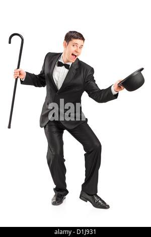 Full length portrait of a young performer with cane and retro hat gesturing isolated on white background Stock Photo