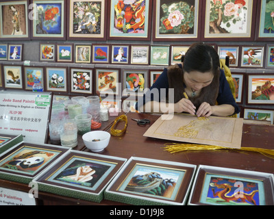 asian female artist painting on canvas doing some art projects on her ...