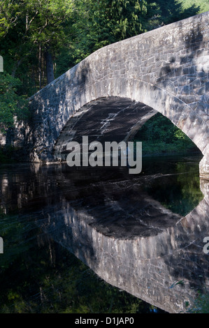 Bridge reflected in the Afon Elan river. Elan Valley, Wales. Stock Photo
