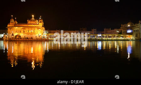 Darbar Sahib, also known as the Golden Temple glowing in night with its reflection in the sacred pool. Darbar Sahib is the most sacred icon for Sikhs. Stock Photo