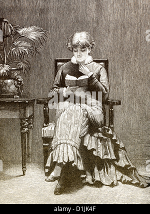 19th century, young woman sitting in an armchair and reading a book, around 1880 Stock Photo