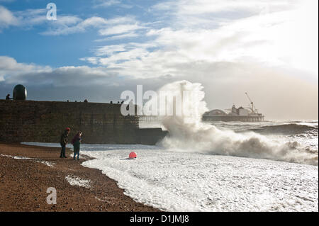 Specatators and swimmers disappointed by bad weather curtailing the annual Christmas Day Swim on Brighton Beach are treated to a display of spectacular waves by Brighton Pier. photo©Julia Claxton Stock Photo