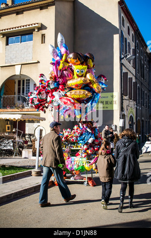 Christmas balloon seller at a village fair in the South of France. Stock Photo