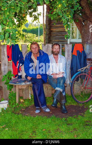 Portrait of two brothers sitting on a bench near the house. Stock Photo