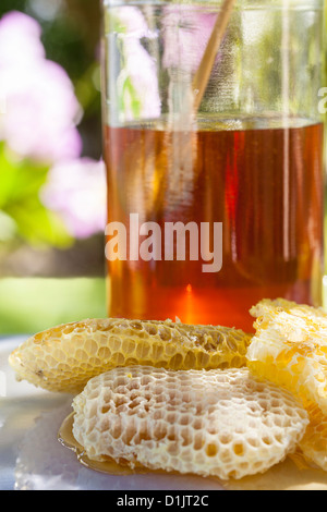 Combs with dipper and jar of sweet honey on grey background Stock Photo ...