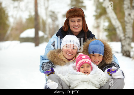 Happy kids and their parents having fun in park Stock Photo