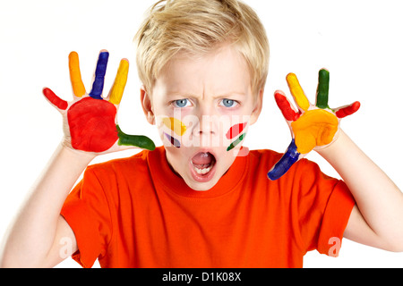 Boy having palms and face covered with paint Stock Photo