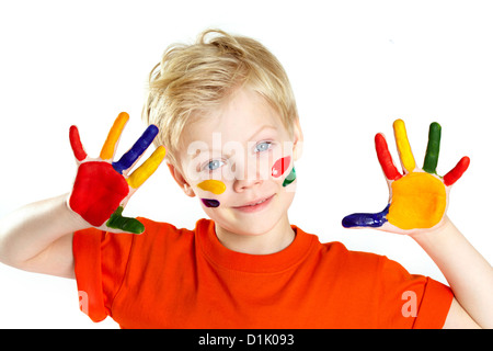 Boy looking at camera with his palms and face covered with paint Stock Photo