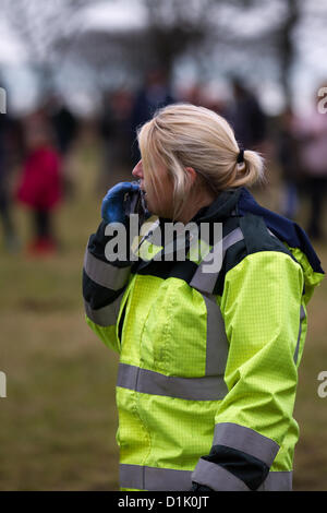Horwich near Bolton, Lancashire Wednesday 26th December, 2012: North West Air Ambulance helicopter crew attends injured female spectator, who had been kicked in the head by a horse, in a field at Rivington where the Holcombe hunt gathered for a Boxing Day event. Stock Photo