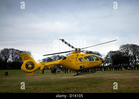 G-NWEM. Eurocopter EC135T2 at Horwich near Bolton, Lancashire Wednesday 26th December, 2012: North West Air Ambulance Charity  helicopter attends injured female spectator, who had been kicked in the head by a horse, in a field at Rivington where the Holcombe hunt gathered for a Boxing Day event. Stock Photo
