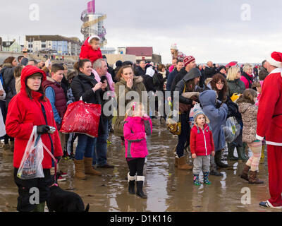 Redcar, Cleveland, UK. 26th December 2012. Large crowd watching the traditional Boxing Day charity  'Dip' at Redcar Cleveland UK. Credit:  Peter Jordan NE / Alamy Live News Stock Photo