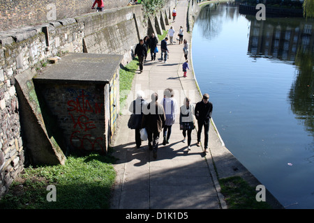 People walking along the Regent's Canal in east London Stock Photo