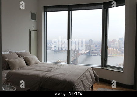 A bedroom in one of the two-bedroom apartments at 8 Spruce St., the residential skyscraper designed by Frank Gehry in Manhattan. Stock Photo