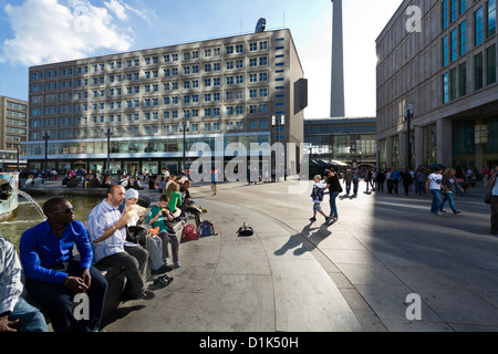 People hanging around at the Fountain of  Friendship between Nations on Alexanderplatz in Berlin, Germany Stock Photo