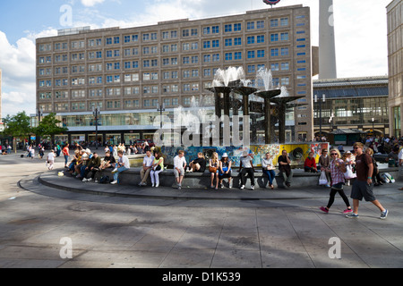 People hanging around at the Fountain of  Friendship between Nations on Alexanderplatz in Berlin, Germany Stock Photo