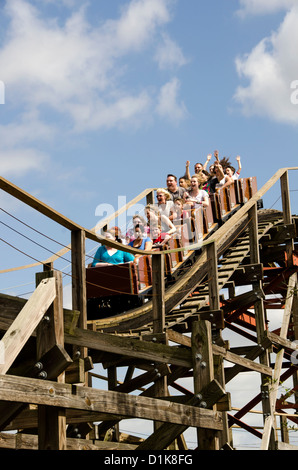 Legoland Florida Coastersaurus wooden roller coaster ride with tourists raising their hands, Winter Haven, FL Stock Photo