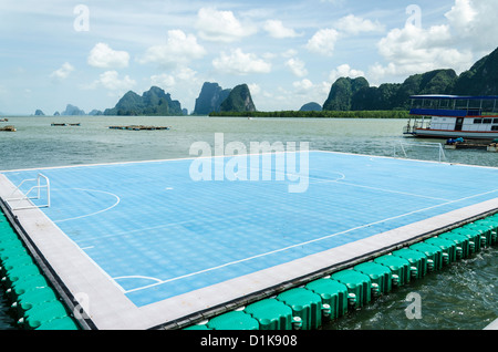 Floating soccer field at Ko Panyi Muslim stilt village with limestone cliffs in background in Ao Phang-Nga Marine National Park Stock Photo