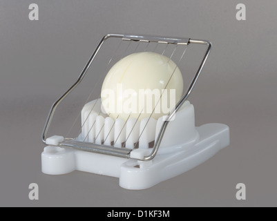 https://l450v.alamy.com/450v/d1kf3m/white-egg-slicer-halfway-through-the-hard-boiled-egg-d1kf3m.jpg