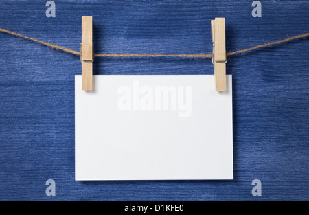 white blank paper card hanging over wood background, template Stock Photo