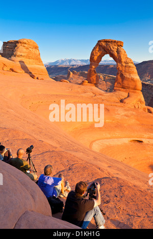 photographers and tourists at Delicate Arch in Arches National Park near Moab Utah USA United states of america Stock Photo